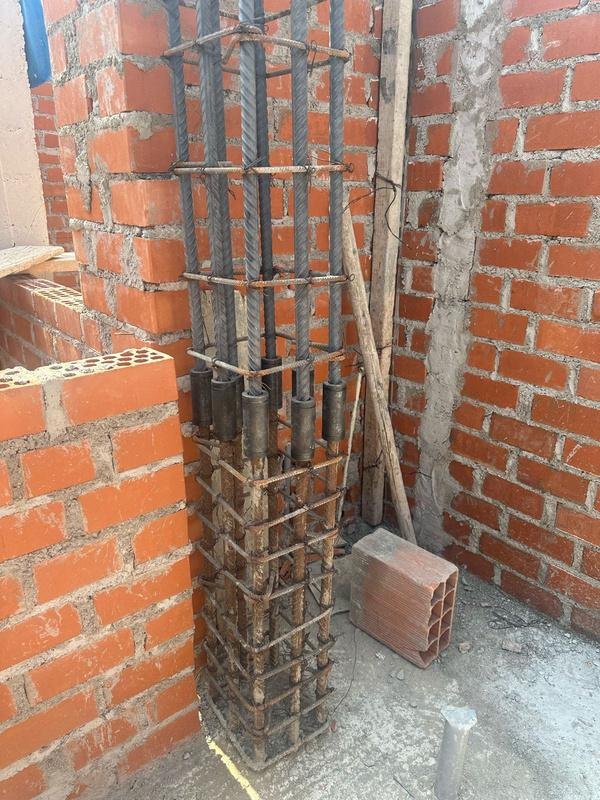 Columna de confinamiento con conectores de un toque entre muros de ladrillo